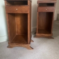 Deux tables de chevet en bois avec des étagères ouvertes et de petits tiroirs, posées sur un sol moquetté près d'un mur. Brocante 93