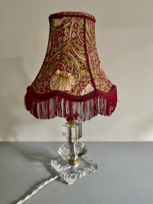 La Lampe pied en verre vintage 1940 est dotée d'une base en cristal et d'un abat-jour floral rouge avec franges, parfait pour ajouter un charme authentique des années 1940 à votre décor. Brocante 93