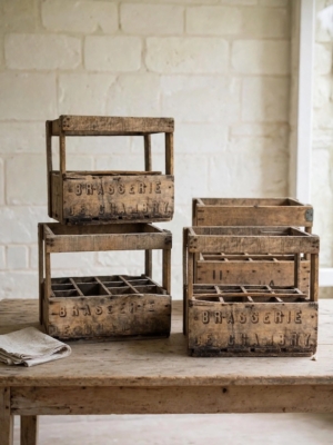 Trois « Caisses de brasserie » vintage datant des années 1950, patinées par le temps, empilées sur une table en bois. Brocante 93