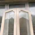 Portes d'ascenseur de 1940 : portes doubles cintrées avec des panneaux vitrés et un cadre en bois clair. Brocante 93