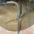 Table à manger ronde vintage des années 1970, avec plateau en verre et piètement en métal chromé. Brocante 93