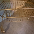 Table basse des années 1950 : chariot-bar à roulettes en métal doré à deux niveaux, avec des étagères vintage en fil métallique. Brocante 93